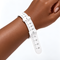 Glorious bracelet sizer wrapped around a wrist, showing the measurement scale.